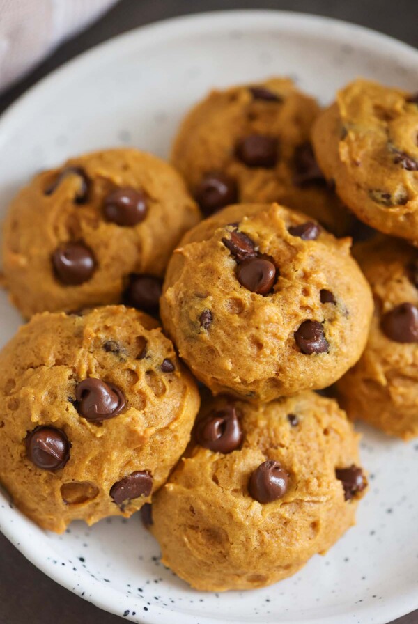pumpkin chocolate chip cookies on a plate.