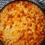 Southern baked mac and cheese in a cast iron skillet.