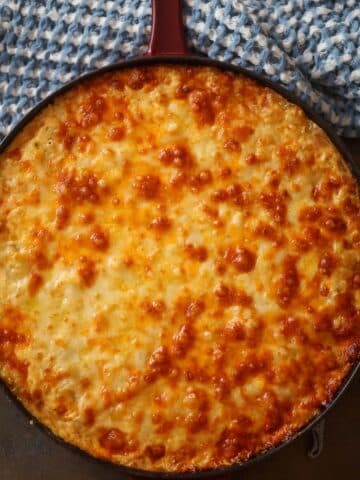Southern baked mac and cheese in a cast iron skillet.