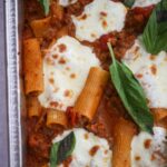 Baked rigatoni with fresh basil on top.