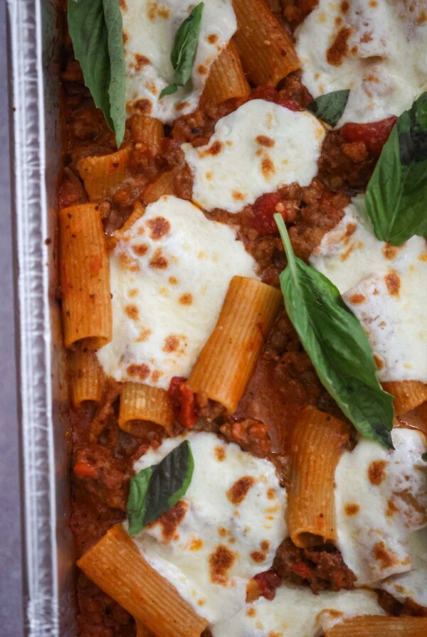 Baked rigatoni with fresh basil on top.