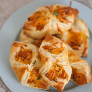 BBQ chicken pastry puffs on a plate with ranch on the side.