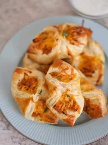 BBQ chicken pastry puffs on a plate with ranch on the side.