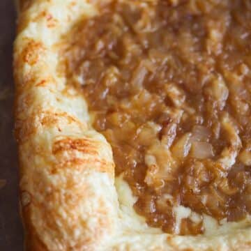 Caramelized onion gruyere tart on a cutting board.