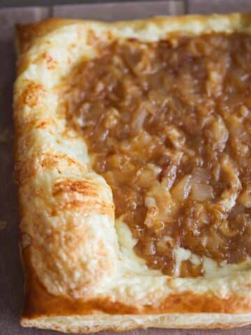 Caramelized onion gruyere tart on a cutting board.