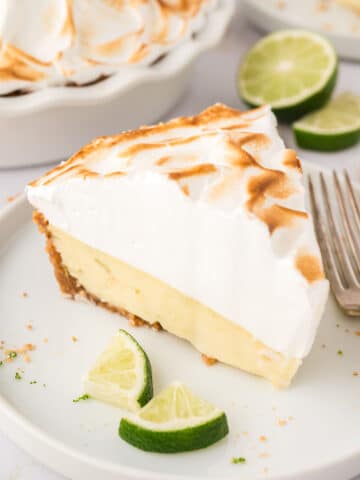 A slice of key lime pie with meringue on top.