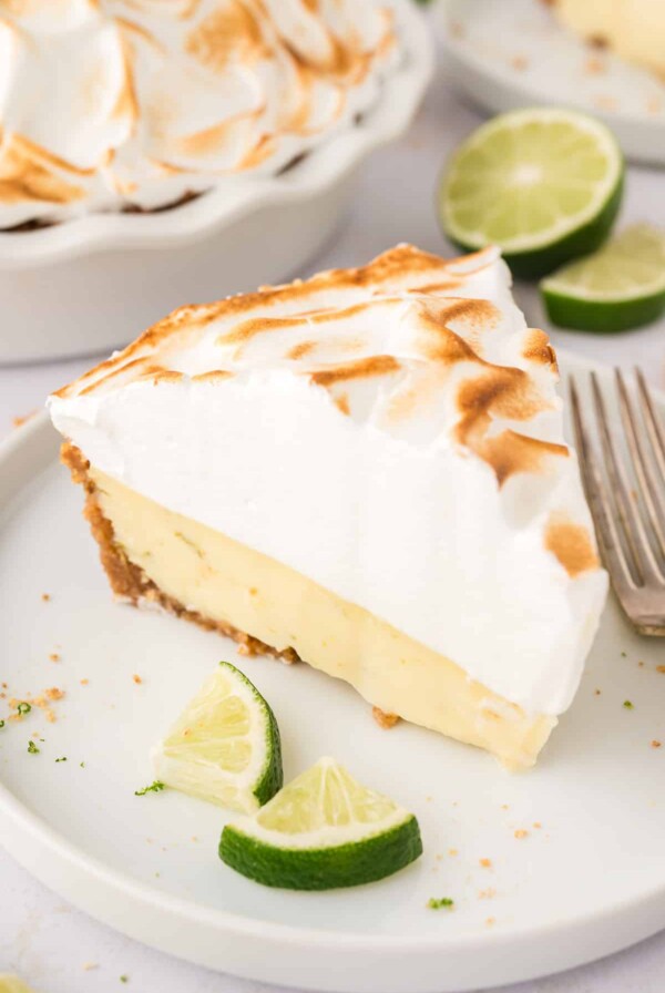 A slice of key lime pie with meringue on top.