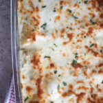 white chicken enchiladas in a 9x13 baking dish.
