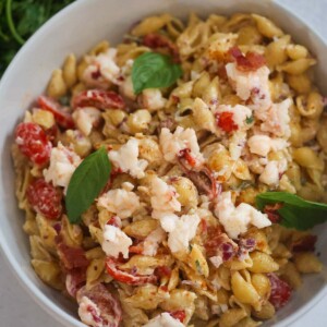 Lobster pasta salad with fresh basil on top.