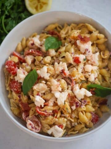 Lobster pasta salad with fresh basil on top.