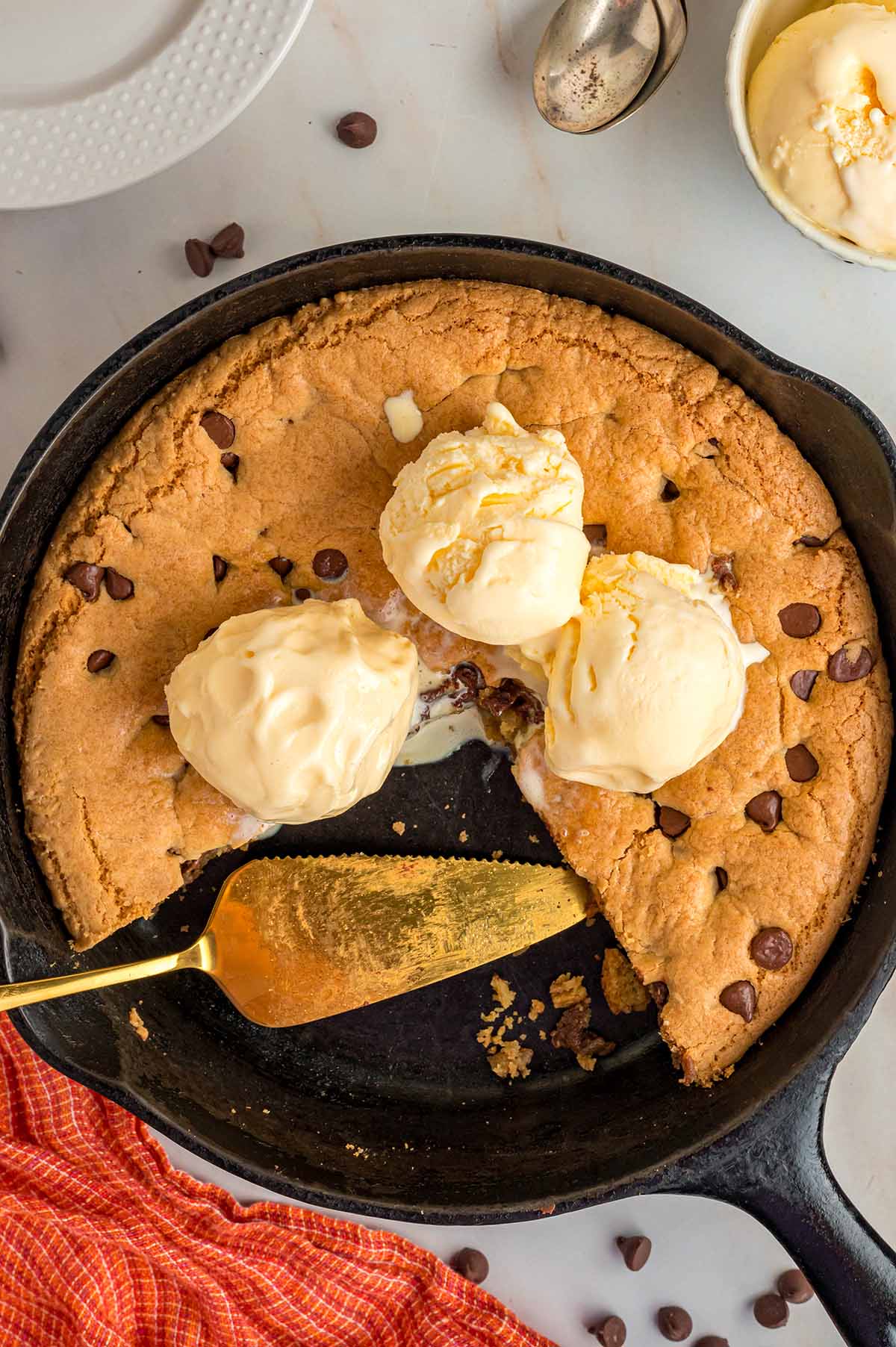 Chocolate chip cookie skillet with three scoops of vanilla ice cream.