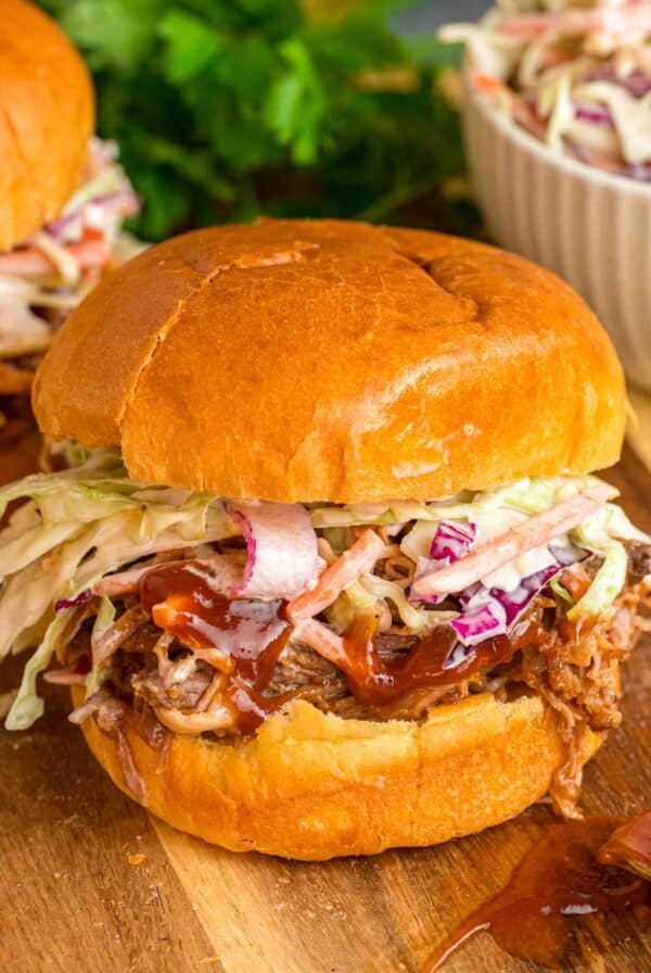 Pulled pork sandwich with coleslaw on top.