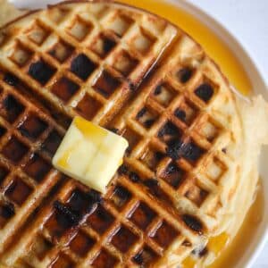 Chocolate chip waffle with butter and syrup.