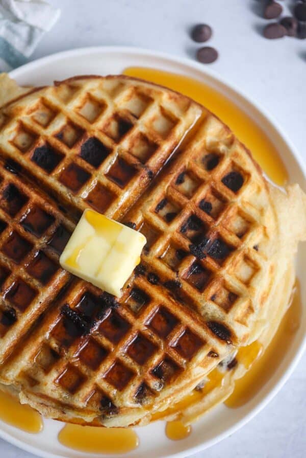 Chocolate chip waffle with butter and syrup.