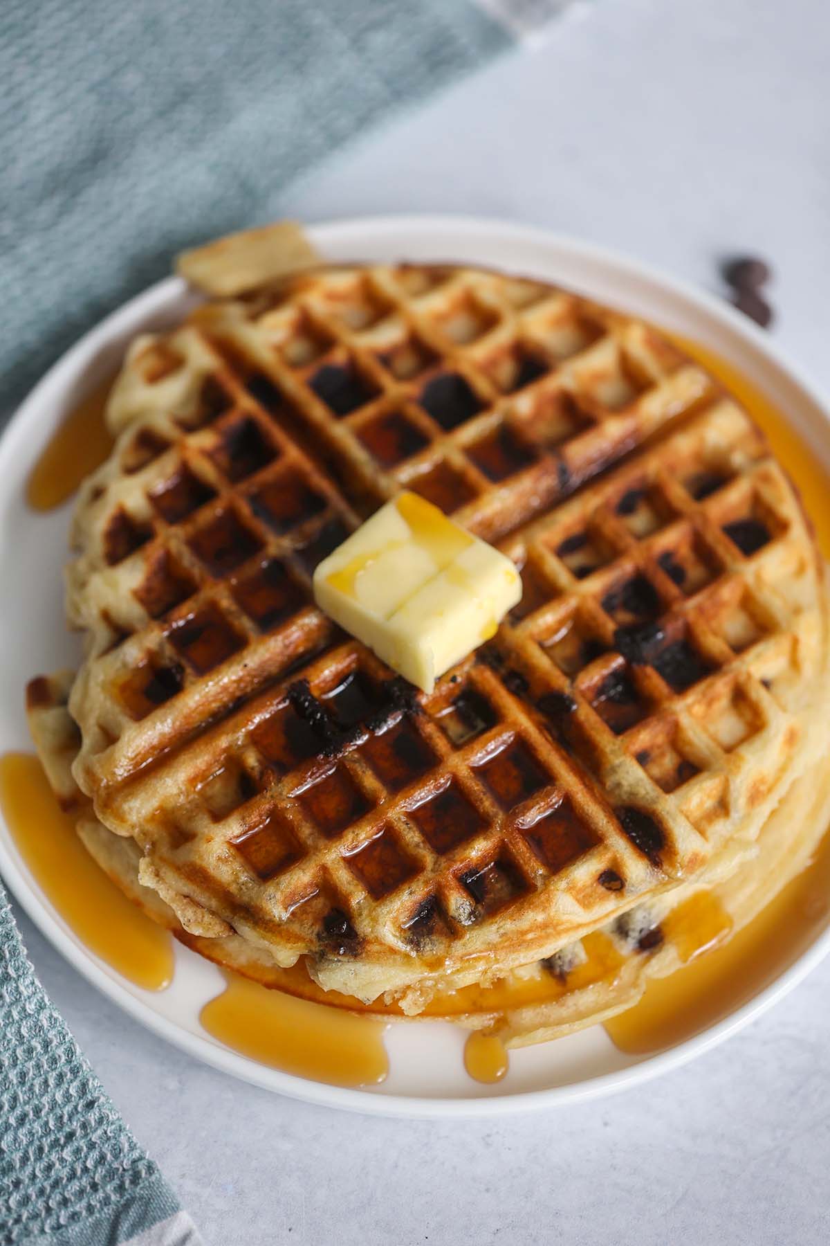 buttermilk chocolate chip waffle on a plate.