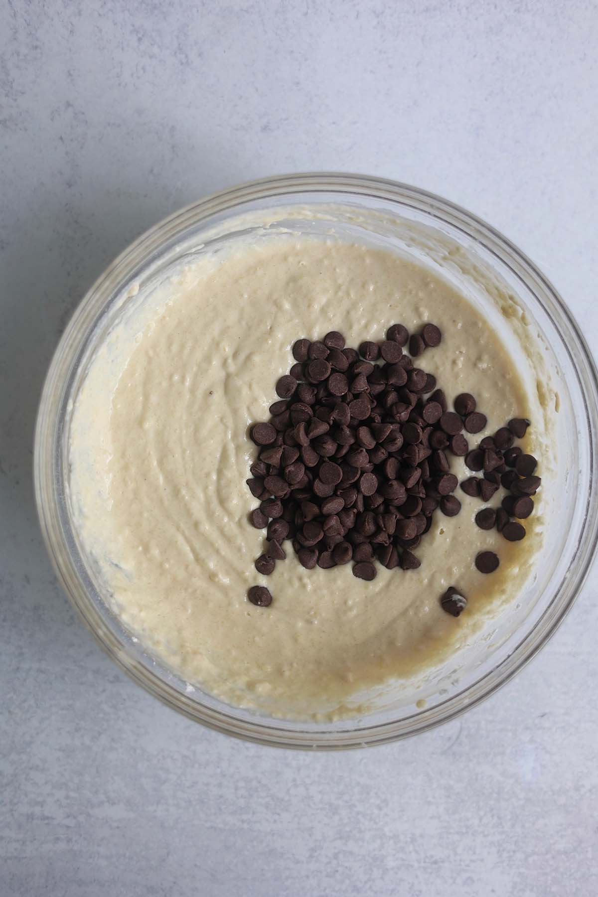 waffle batter with chocolate chips in a glass bowl.