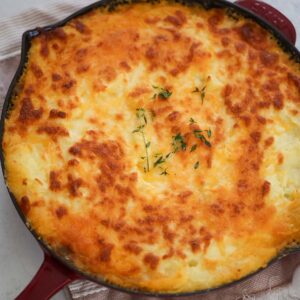 Cottage pie in a red skillet.