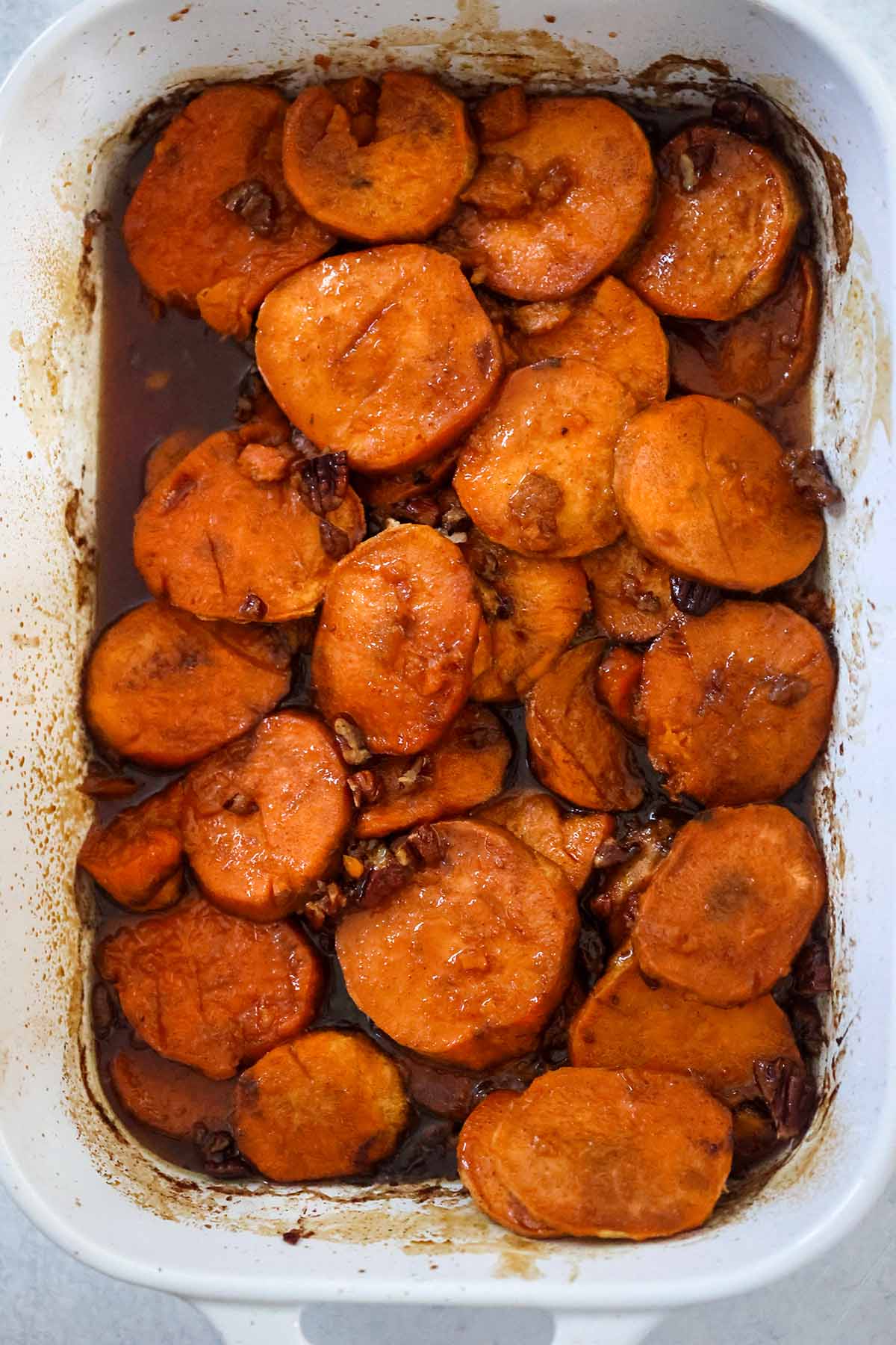 Baked yams in a white 9x13 casserole dish.