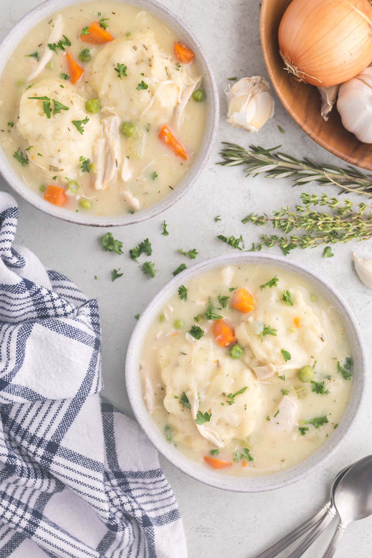 Two small bowls filled with chicken and dumplings. 