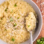 A bowl of pastina with parmesan cheese and parsley on top.