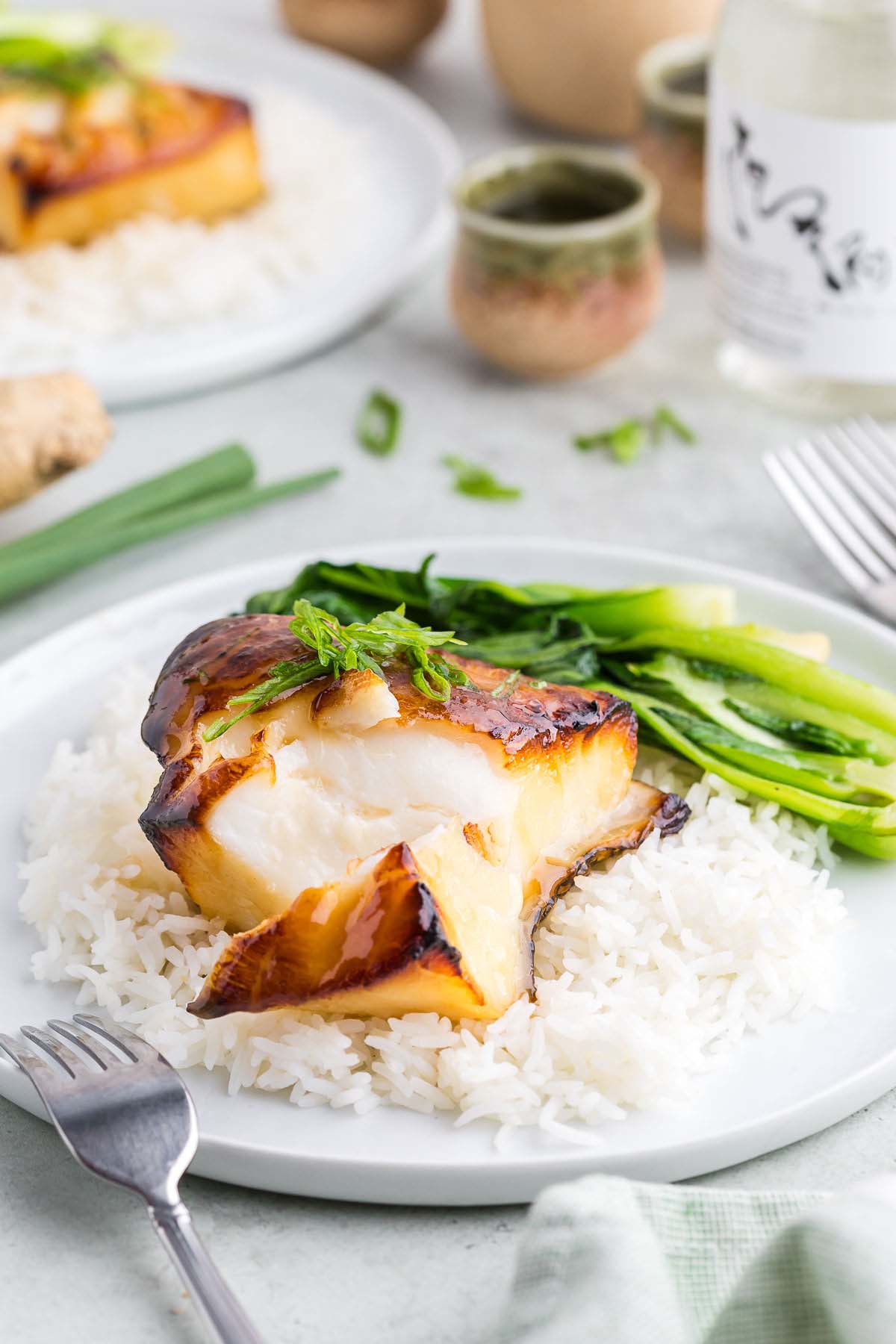Chilean sea bass on a plate with a fork on the side. 