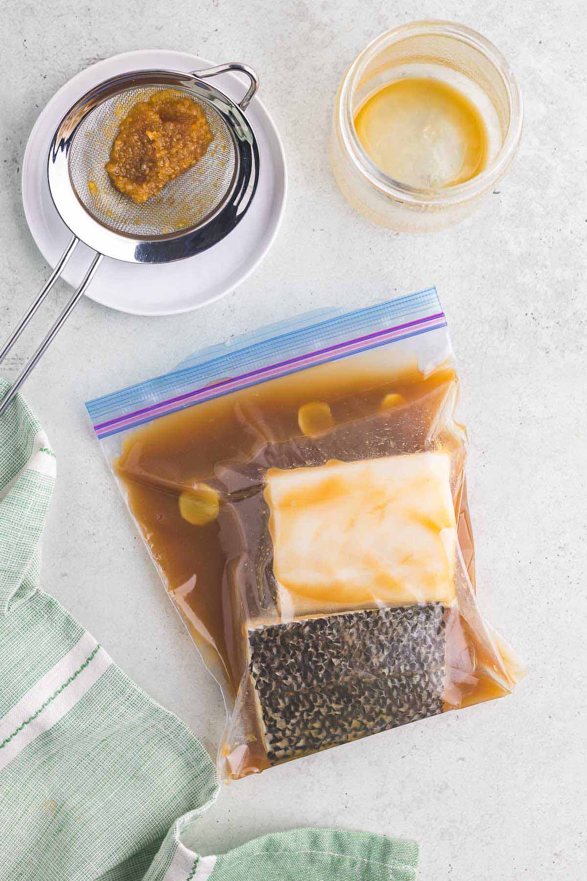 Chilean sea bass in a plastic bag with a marinade. 