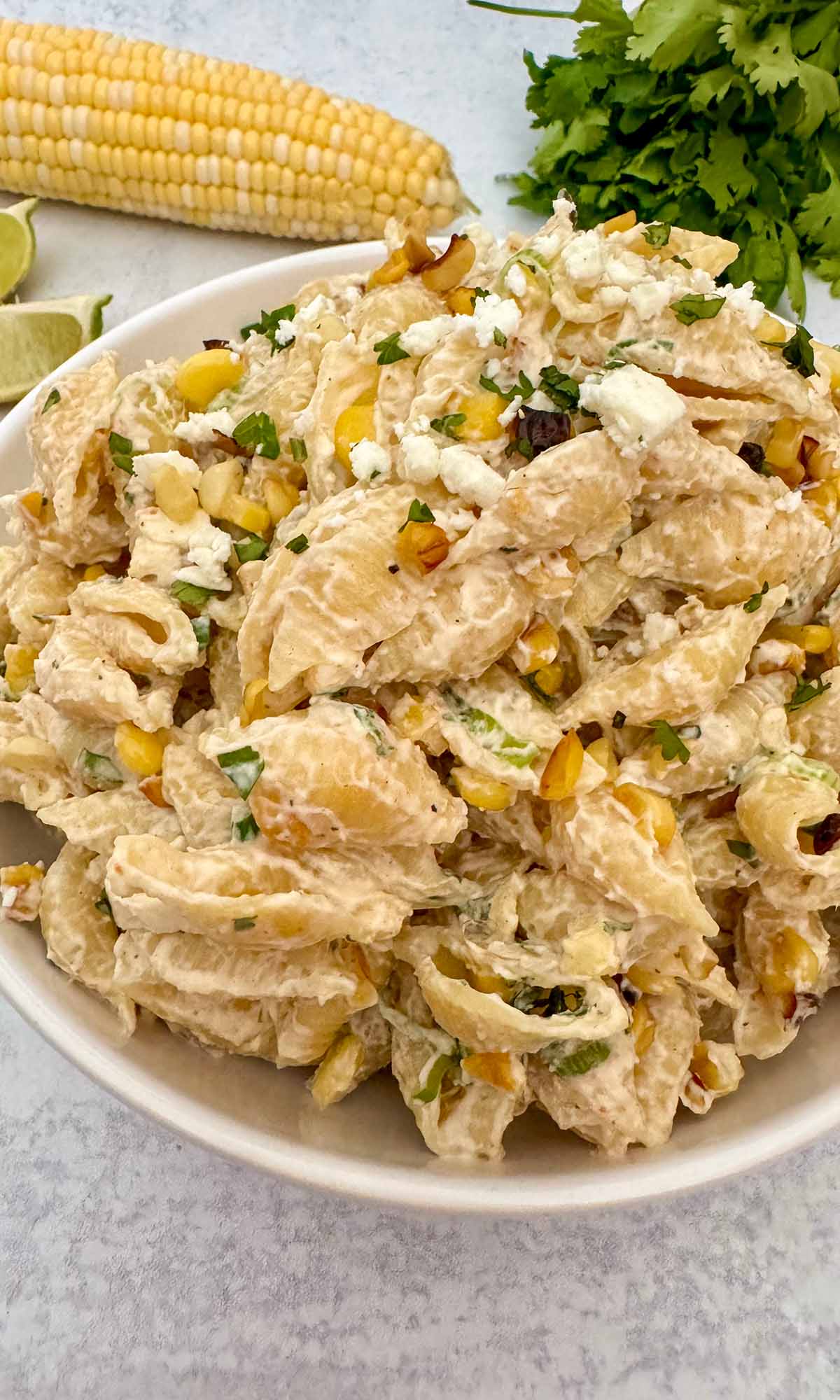 elote pasta salad in a white bowl.