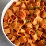 lobster pasta in a white bowl.