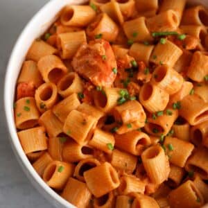lobster pasta in a white bowl.