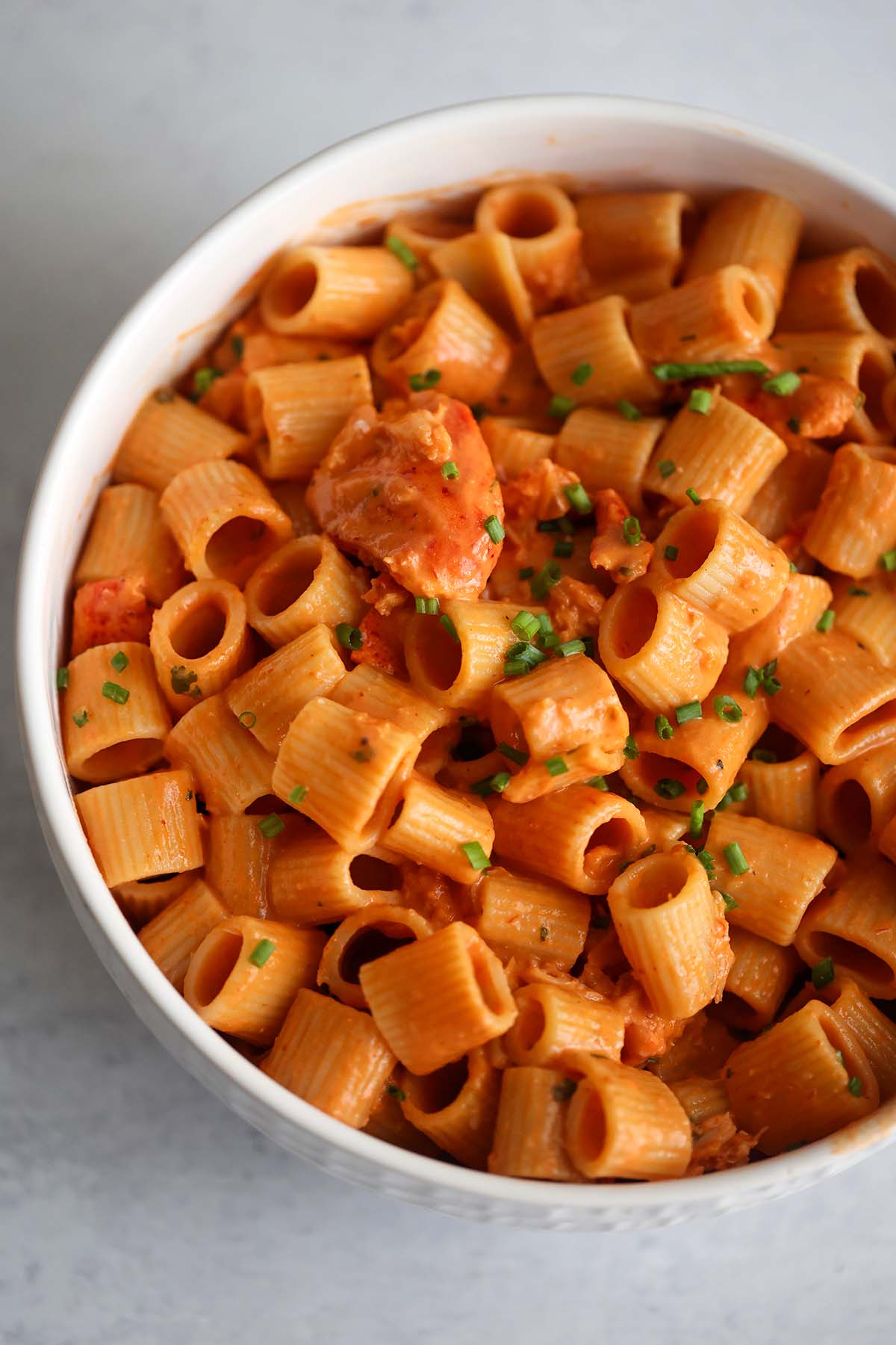 lobster pasta in a white bowl.