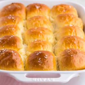 Baked parker house rolls with honey butter on the side.