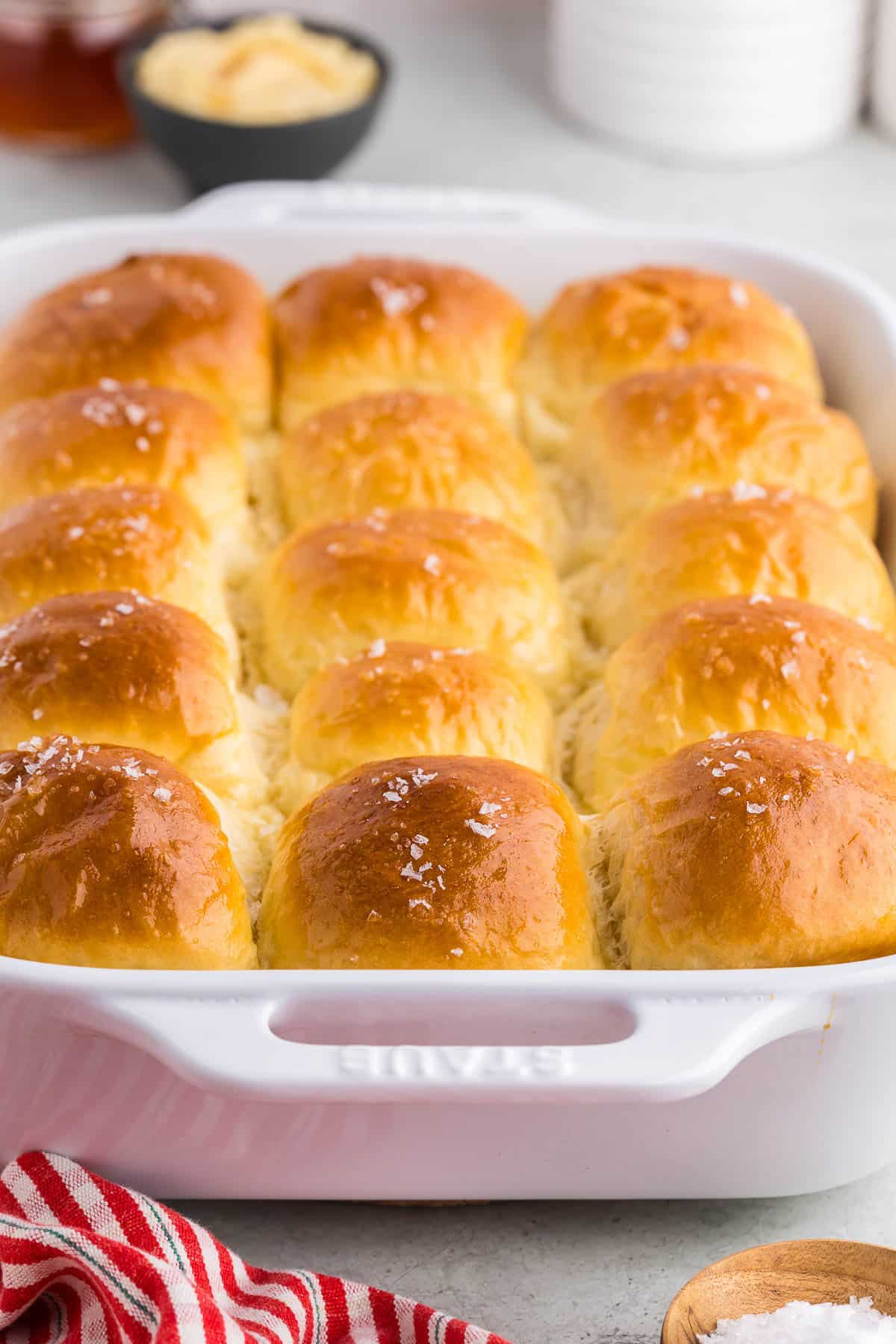 Baked parker house rolls with honey butter on the side.