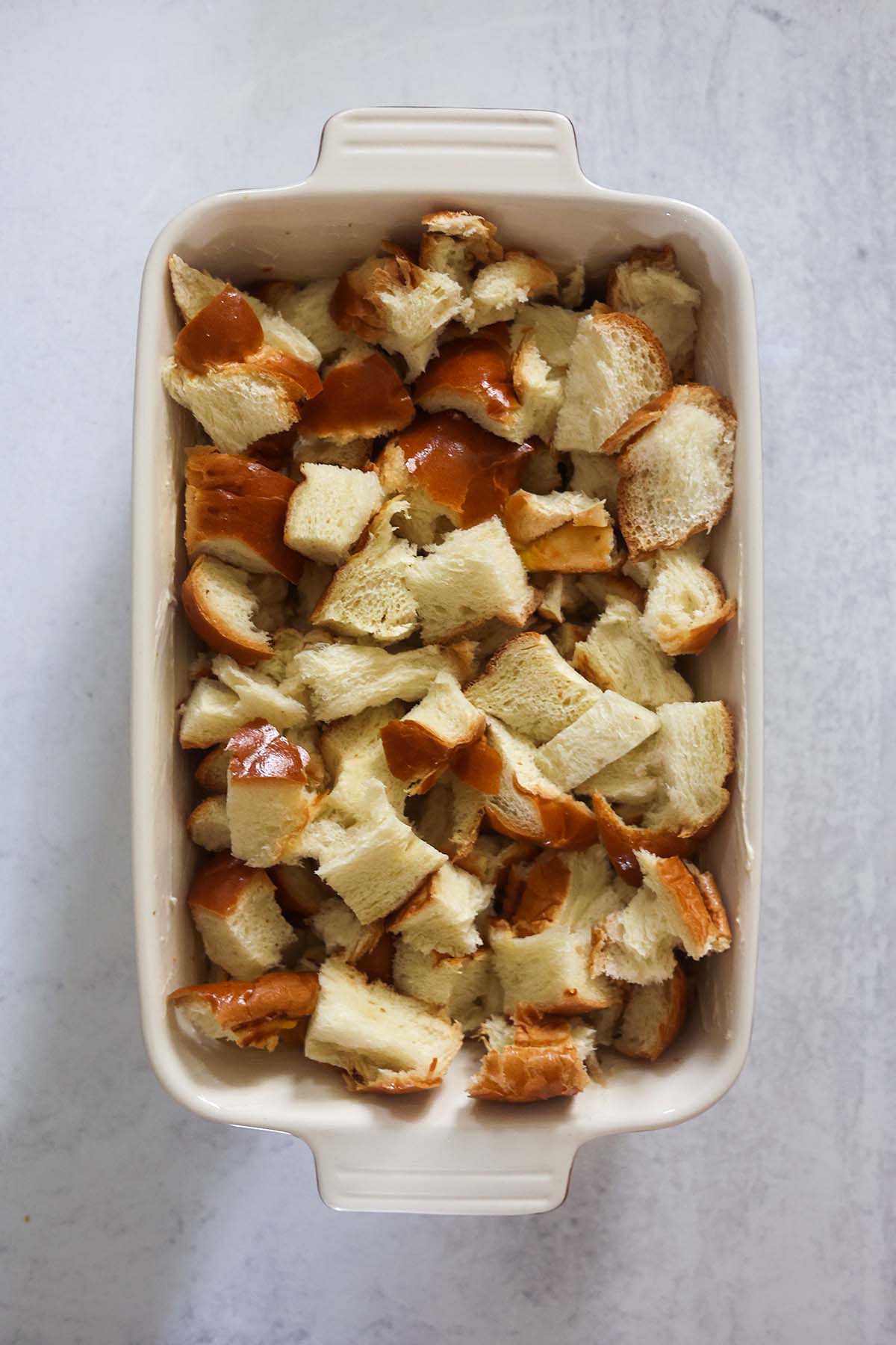Bread cubes in a baking dish.