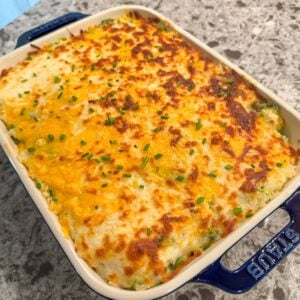broccoli rice casserole in a 9x9 blue baking dish.