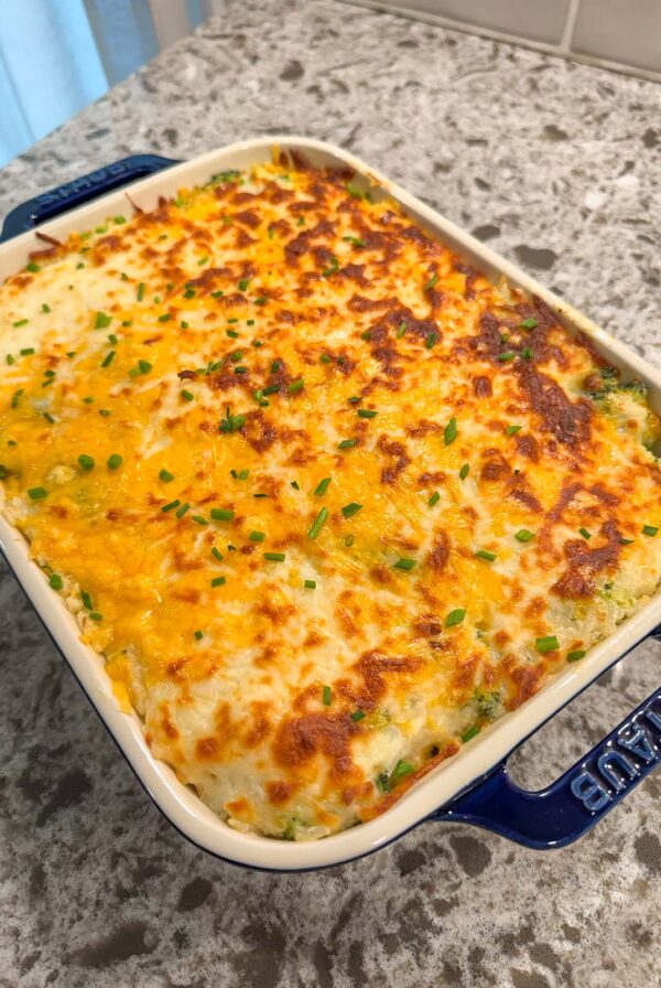 broccoli rice casserole in a 9x9 blue baking dish.