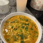 chicken barley soup in a white bowl.