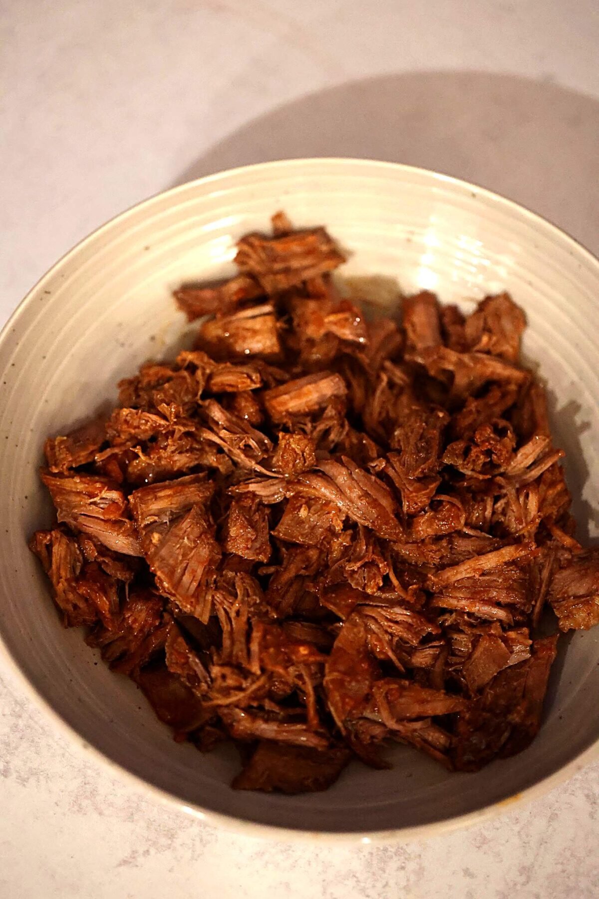 Shredded beef in a bowl.