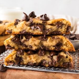 Three chocolate chip cookies cut in half and stacked, showing the melted chocolate chips inside.