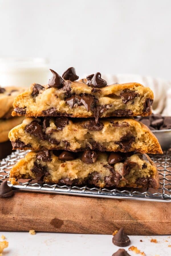 Three chocolate chip cookies cut in half and stacked, showing the melted chocolate chips inside.