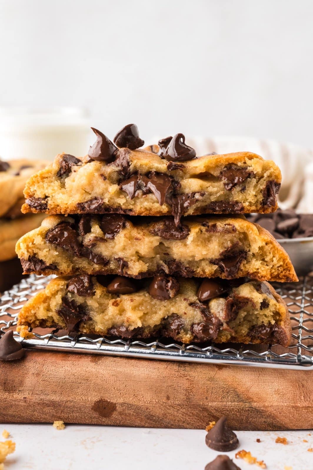Three chocolate chip cookies cut in half and stacked, showing the melted chocolate chips inside.
