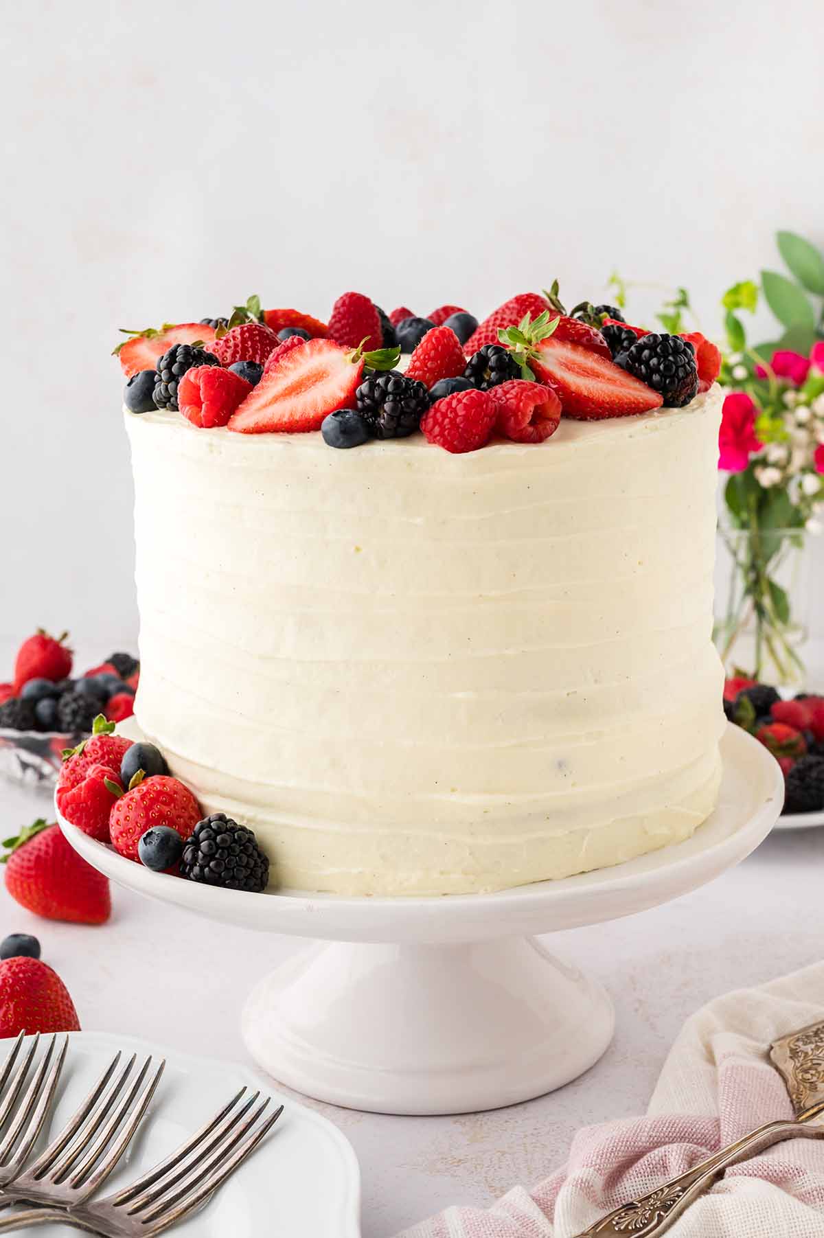 Frosted cake with berries on top.