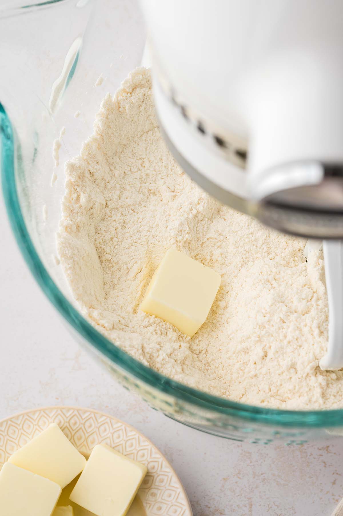 Butter and flour being mixed in a stand mixer.