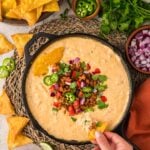 queso with chorizo, jalapeños, tomatoes, onions, and cilantro on top.