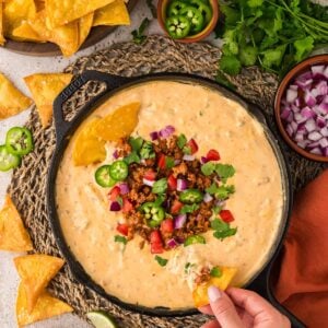 queso with chorizo, jalapeños, tomatoes, onions, and cilantro on top.