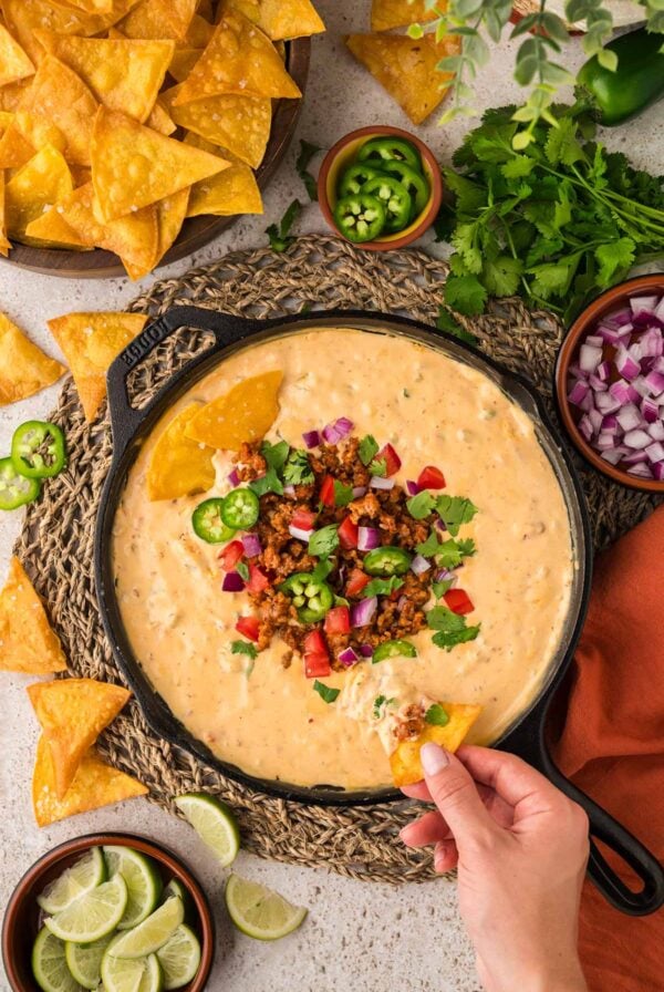 queso with chorizo, jalapeños, tomatoes, onions, and cilantro on top.