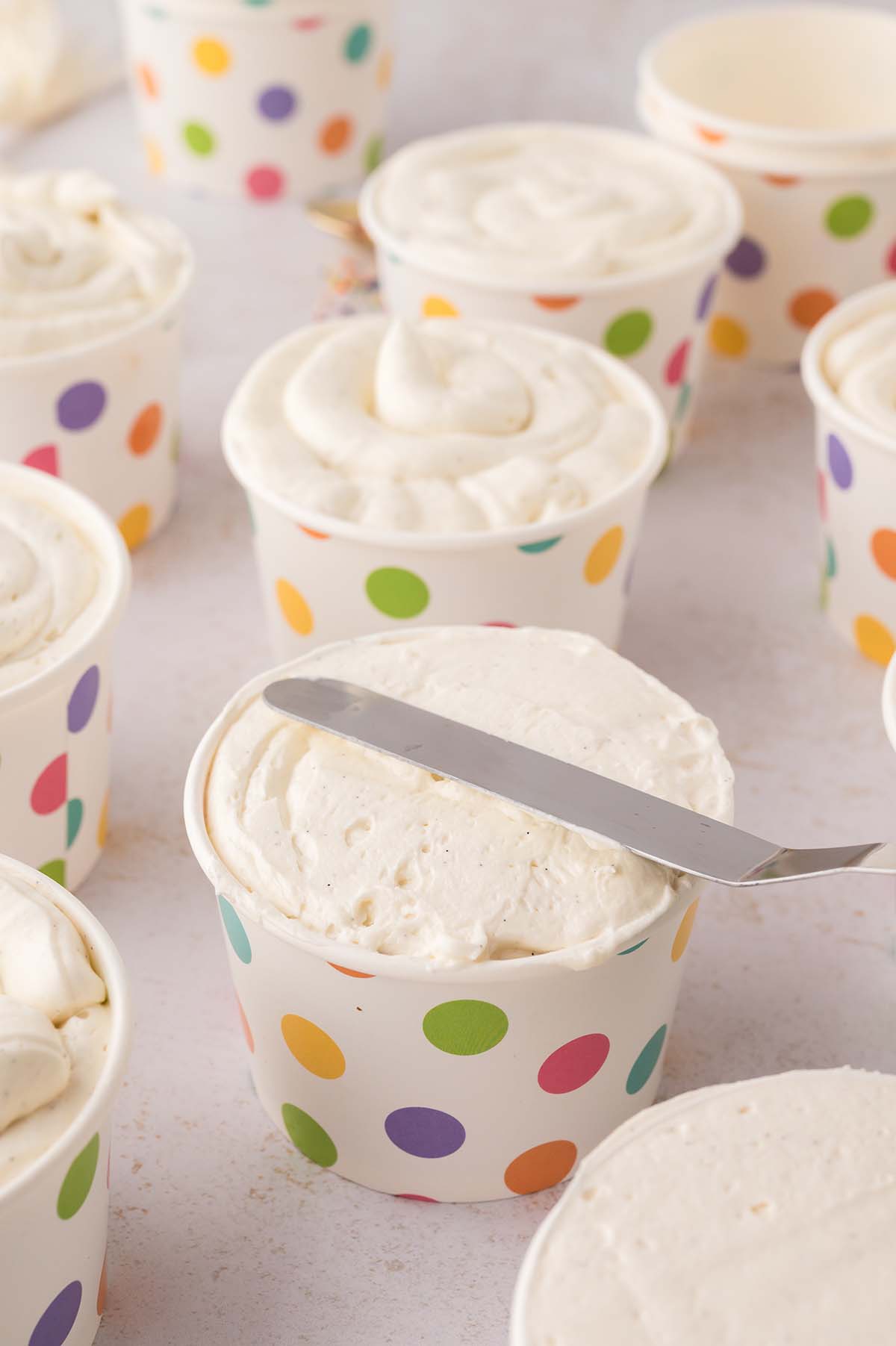 Offset spatula smoothing the buttercream frosting.