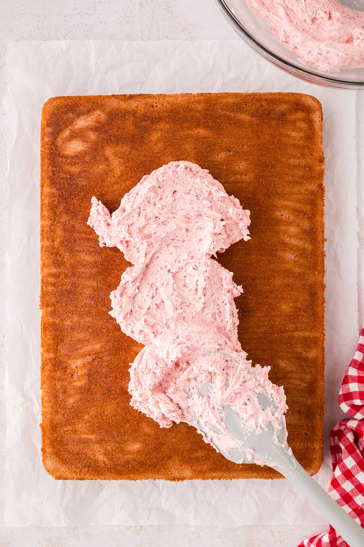 Cake being frosted with buttercream.