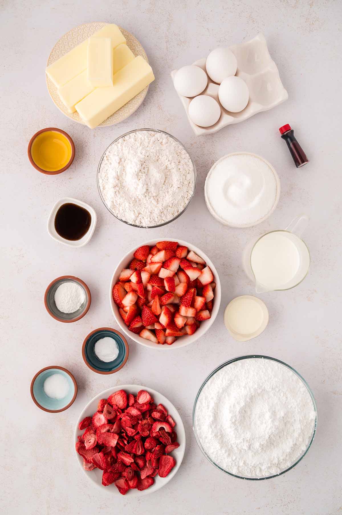 Butter, eggs, flour, food coloring, sugar, vanilla extract, fresh strawberries, buttermilk, freeze dried strawberries, salt, and leaving agents.