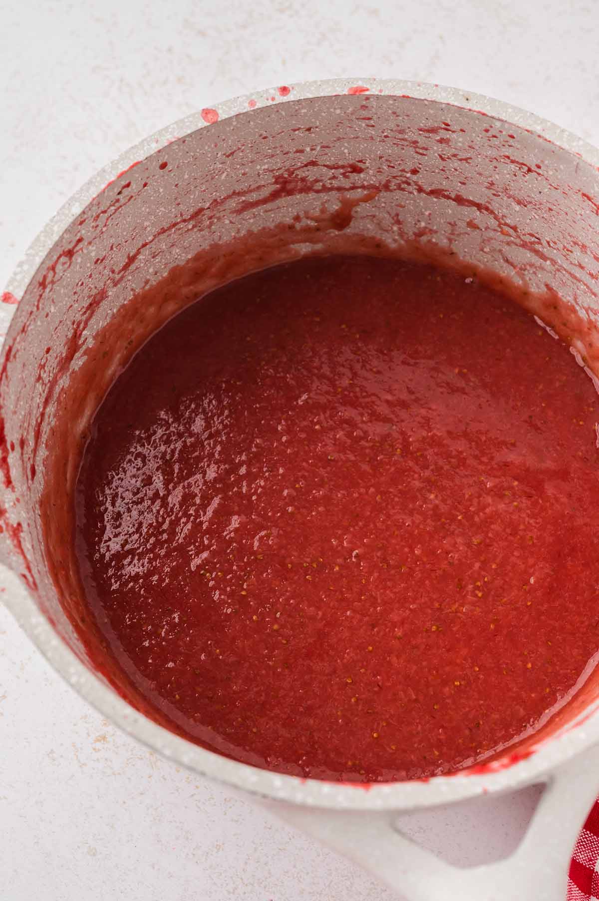 Strawberry puree in a saucepan.