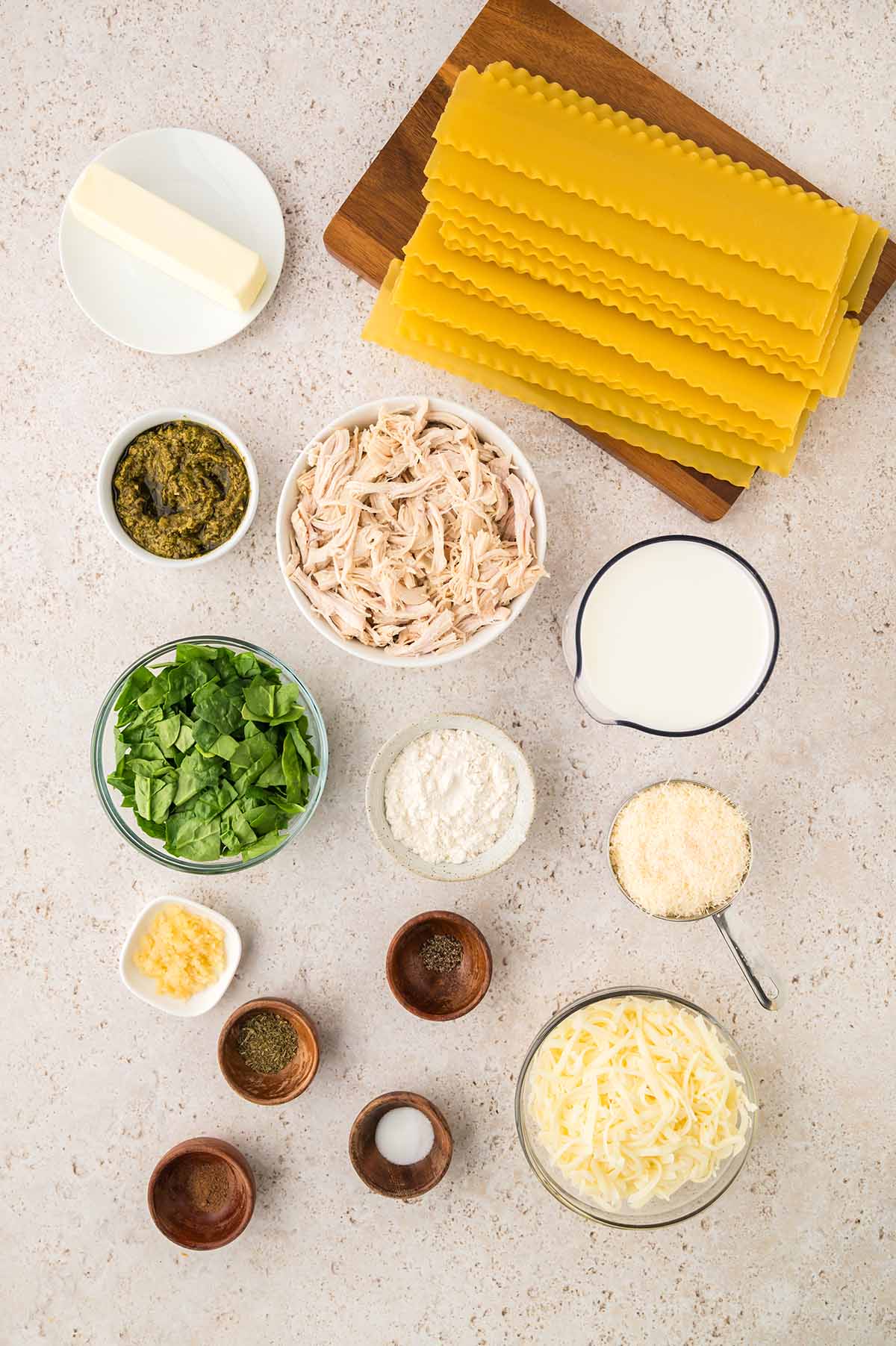 Lasgana noodles, chicken, pesto, spinach, spices, butter, cheese, milk, flour, and spices.